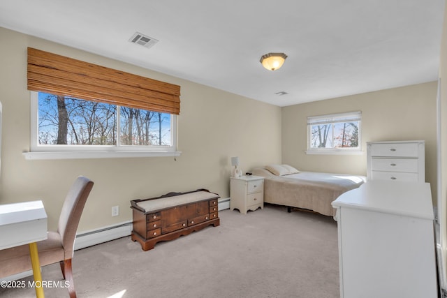 carpeted bedroom featuring visible vents and baseboard heating