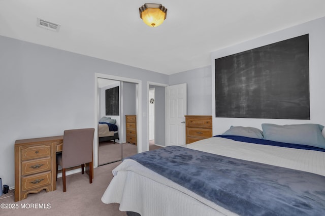 carpeted bedroom with a closet and visible vents