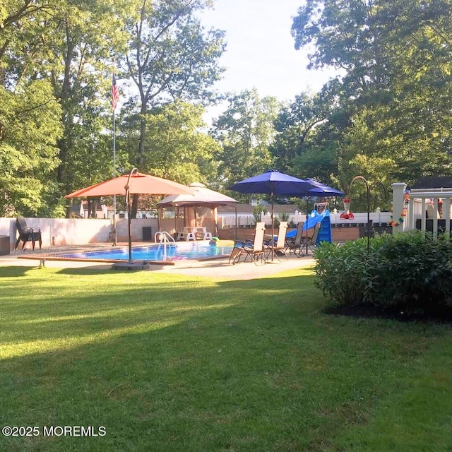 view of yard with a gazebo, a fenced in pool, a patio, and fence