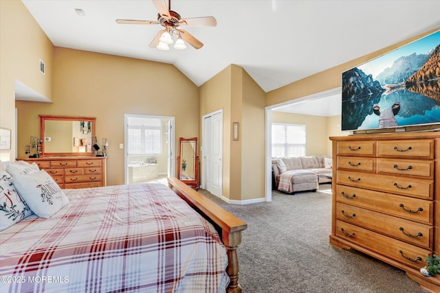 carpeted bedroom featuring lofted ceiling, ensuite bathroom, a ceiling fan, baseboards, and visible vents