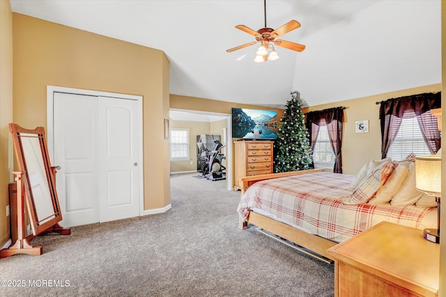 bedroom with baseboards, lofted ceiling, ceiling fan, carpet floors, and a closet