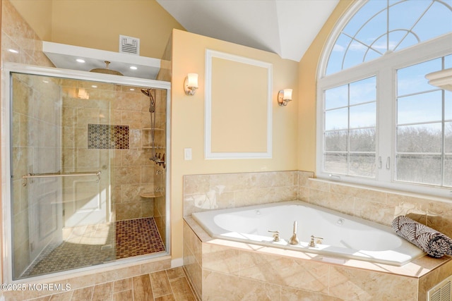 bathroom with lofted ceiling, a garden tub, visible vents, a healthy amount of sunlight, and a stall shower