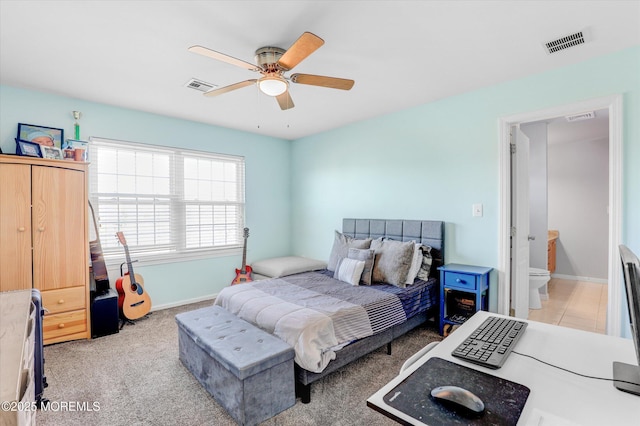 bedroom with baseboards, visible vents, a ceiling fan, and light colored carpet