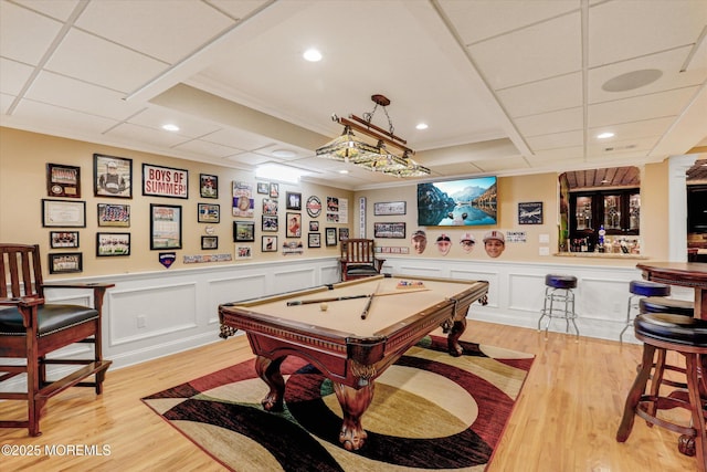 recreation room featuring a paneled ceiling, light wood-style floors, ornamental molding, and pool table