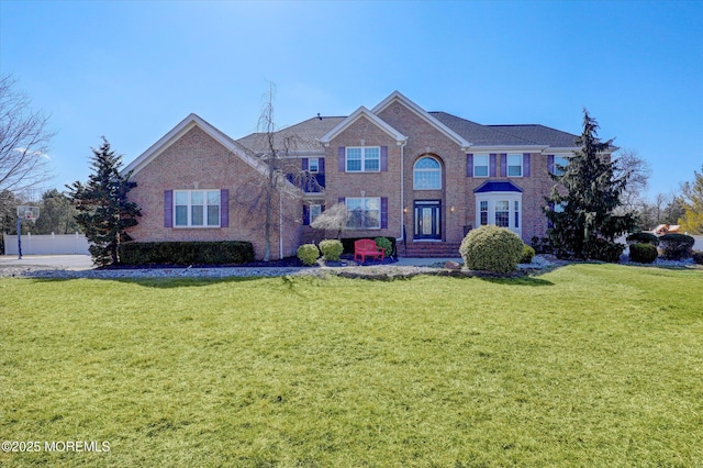 view of front of house featuring brick siding and a front lawn