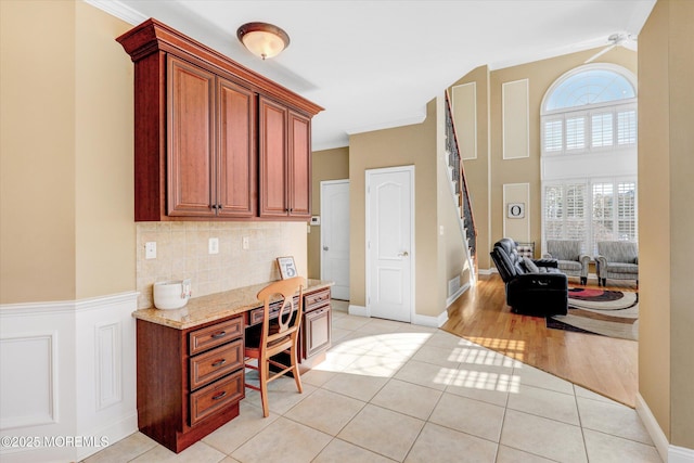 home office with ornamental molding and light tile patterned flooring