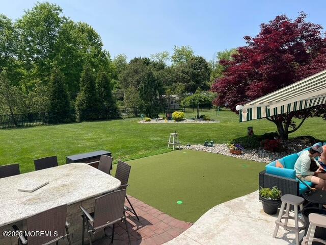 view of yard featuring fence and a patio