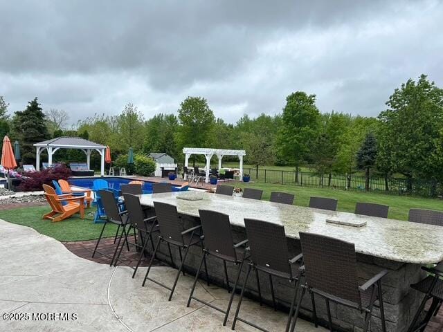 view of patio / terrace with outdoor dry bar, a gazebo, fence, and a pergola