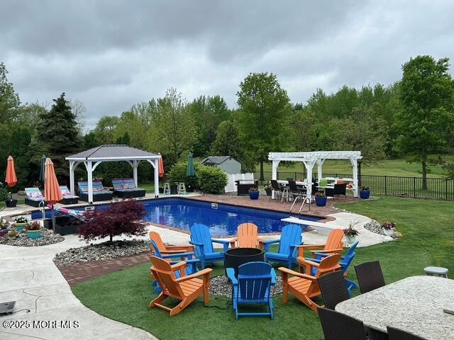 view of pool featuring a fenced in pool, a gazebo, a patio area, fence, and a pergola