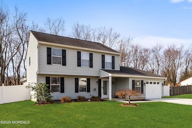 colonial house featuring fence, roof with shingles, concrete driveway, a front lawn, and a garage