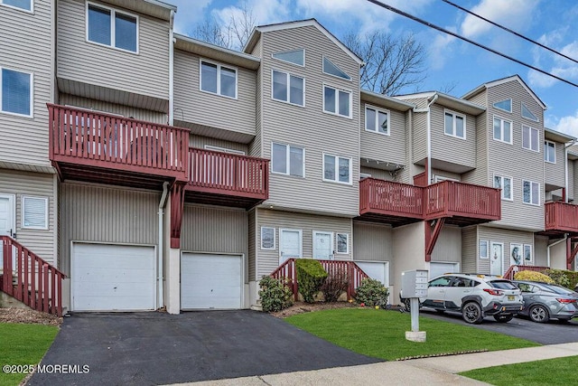 exterior space featuring a residential view, a garage, and driveway