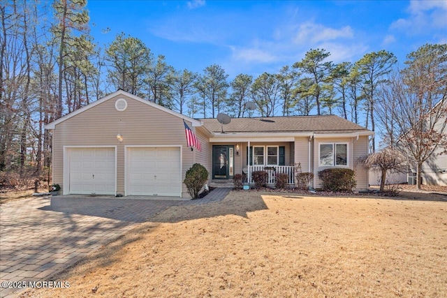 ranch-style house featuring a garage, a porch, and decorative driveway