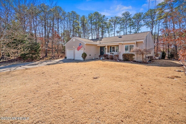 single story home with a porch, driveway, and an attached garage