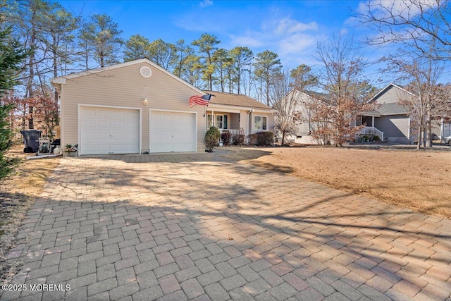 single story home with decorative driveway and an attached garage