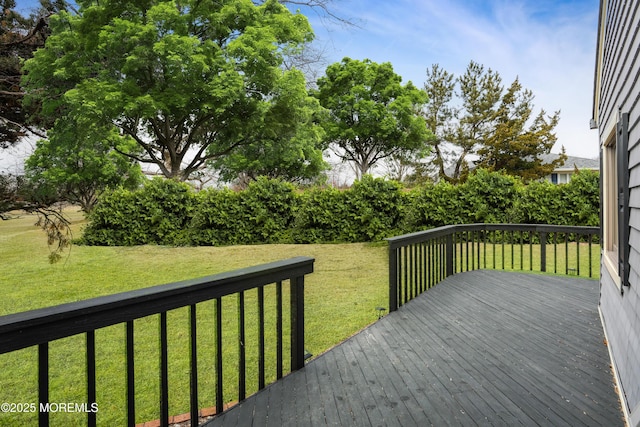 wooden terrace with a lawn