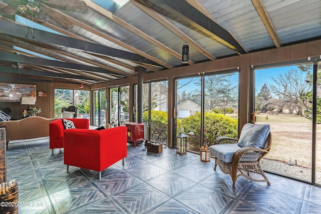 sunroom with lofted ceiling with beams and a wood stove