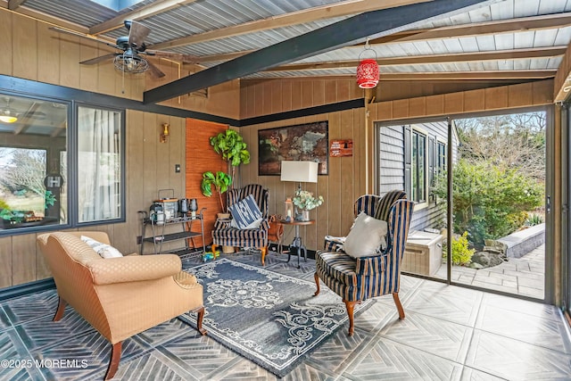 sunroom with a ceiling fan and vaulted ceiling with beams