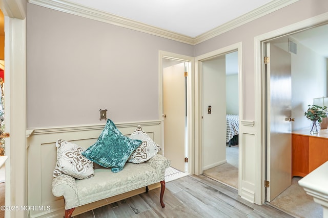 mudroom with visible vents, crown molding, and wood finished floors