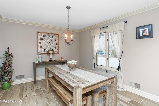 dining room featuring light wood-style floors, visible vents, and ornamental molding