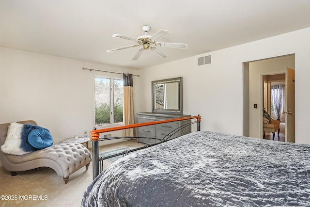 carpeted bedroom with visible vents and a ceiling fan