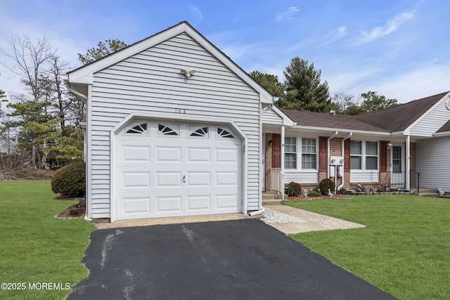 ranch-style house with aphalt driveway, a front yard, brick siding, and an attached garage