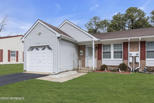 ranch-style home with an attached garage, aphalt driveway, a front lawn, and brick siding