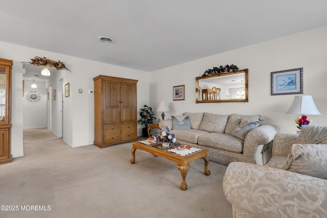 living room featuring light carpet and visible vents