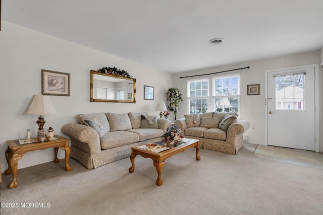 living room featuring visible vents and light colored carpet