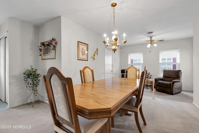 dining area with an inviting chandelier, visible vents, and light colored carpet