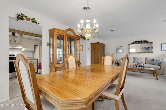 dining room featuring light colored carpet, a notable chandelier, and visible vents