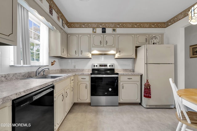 kitchen featuring black dishwasher, stainless steel electric stove, freestanding refrigerator, a sink, and under cabinet range hood