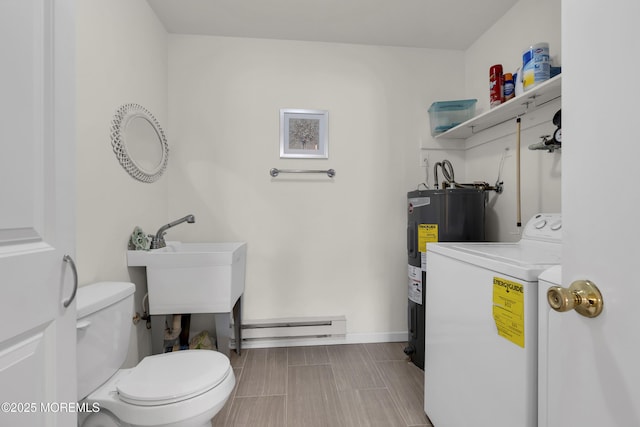 half bathroom with washer / clothes dryer, toilet, a baseboard heating unit, electric water heater, and baseboards