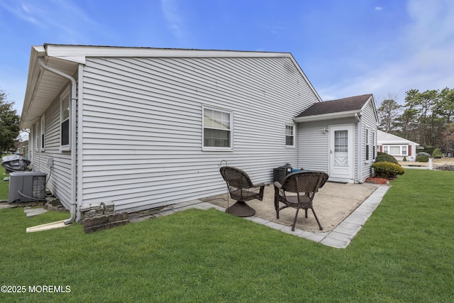 rear view of property with a patio area, a lawn, and central AC unit