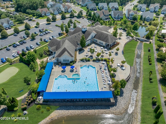 drone / aerial view featuring a residential view and a water view