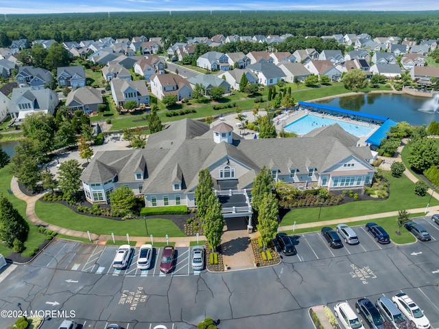 drone / aerial view featuring a water view and a residential view