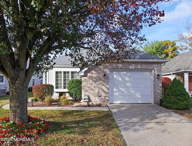 view of front of house featuring an attached garage, central AC, brick siding, concrete driveway, and roof with shingles