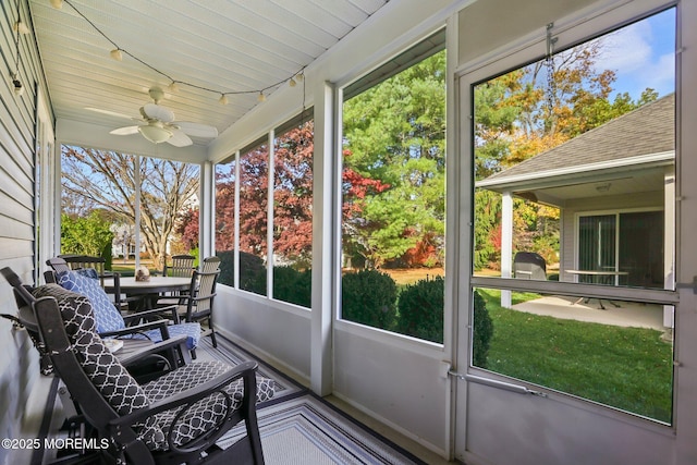 unfurnished sunroom with a healthy amount of sunlight, wooden ceiling, and a ceiling fan