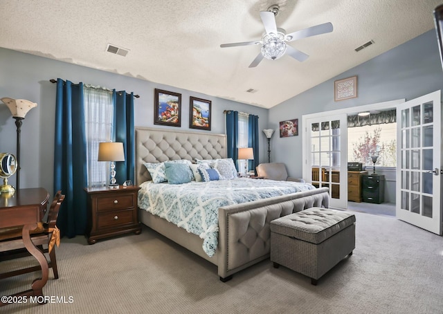 bedroom featuring lofted ceiling, a textured ceiling, light colored carpet, visible vents, and french doors