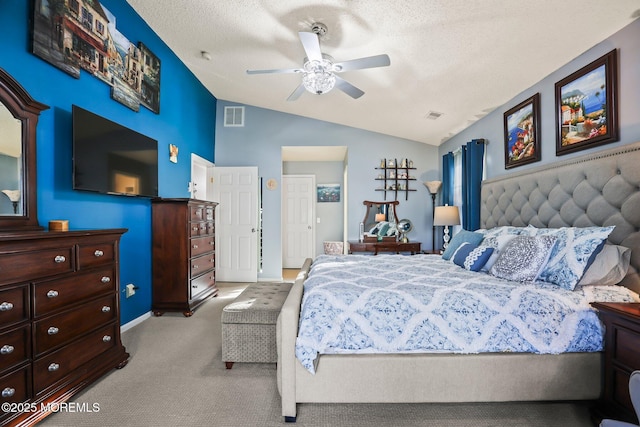 bedroom featuring lofted ceiling, a textured ceiling, carpet, and visible vents