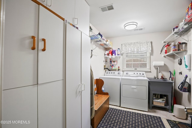 laundry area featuring laundry area, visible vents, and washer and clothes dryer