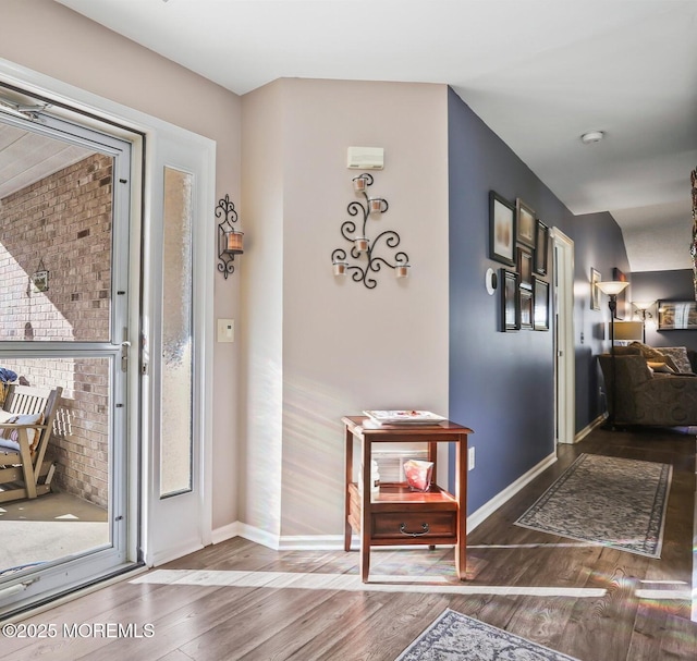 entrance foyer featuring baseboards and wood finished floors