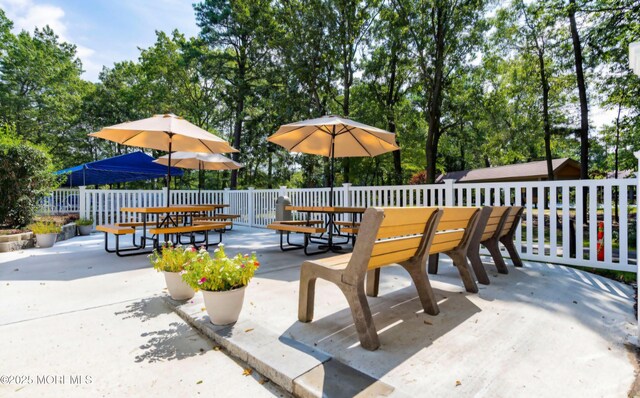 view of patio featuring outdoor dining space and fence