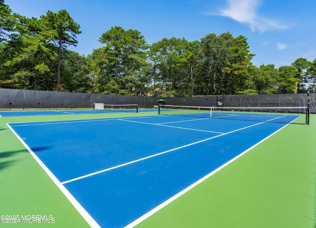 view of tennis court with fence