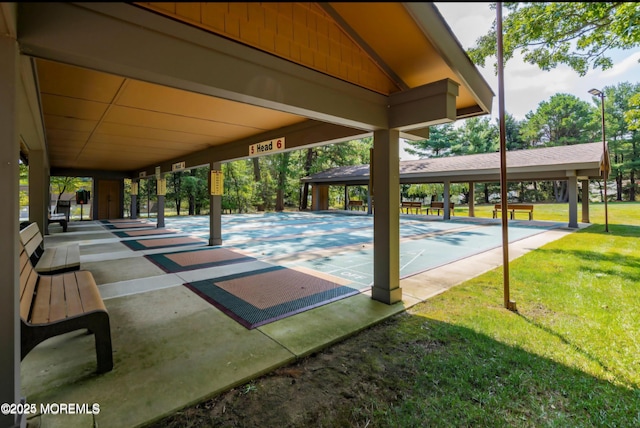 surrounding community with shuffleboard and a lawn