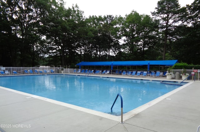 pool with fence and a patio