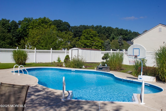 view of pool with a fenced in pool, a fenced backyard, and a patio area