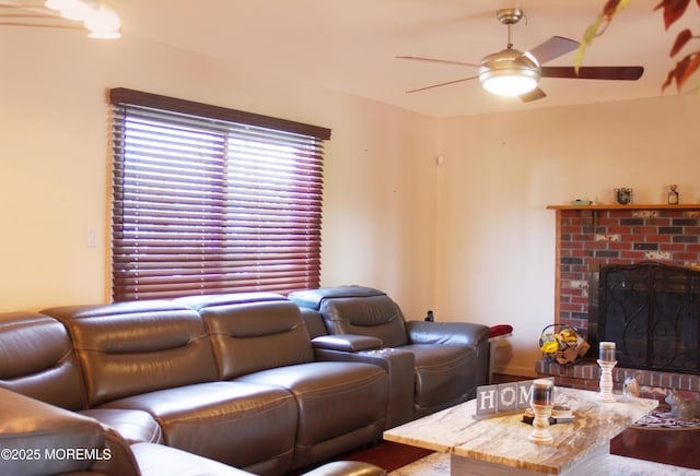 living room featuring a brick fireplace and ceiling fan