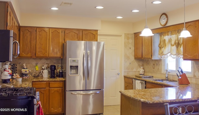 kitchen with visible vents, brown cabinets, appliances with stainless steel finishes, and light stone countertops