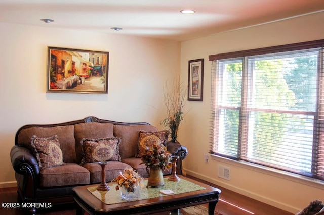 living area featuring visible vents, recessed lighting, baseboards, and wood finished floors