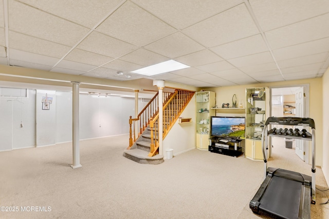 interior space featuring a paneled ceiling, carpet floors, and stairs